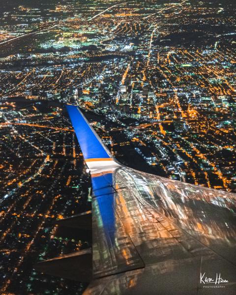 Airplane Wing Over New York at Night