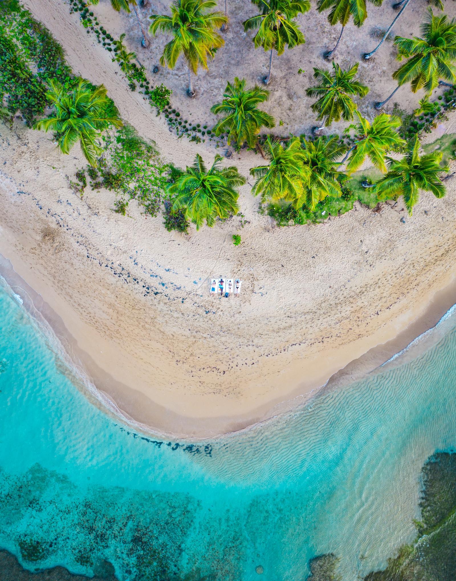 Group of People Lying on a Beach Towel Drone Top Down