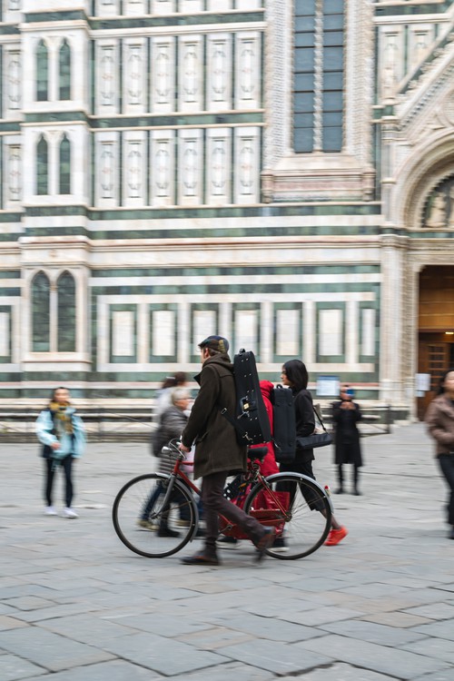 Man Walking Bike in Front of Duomo in Florence